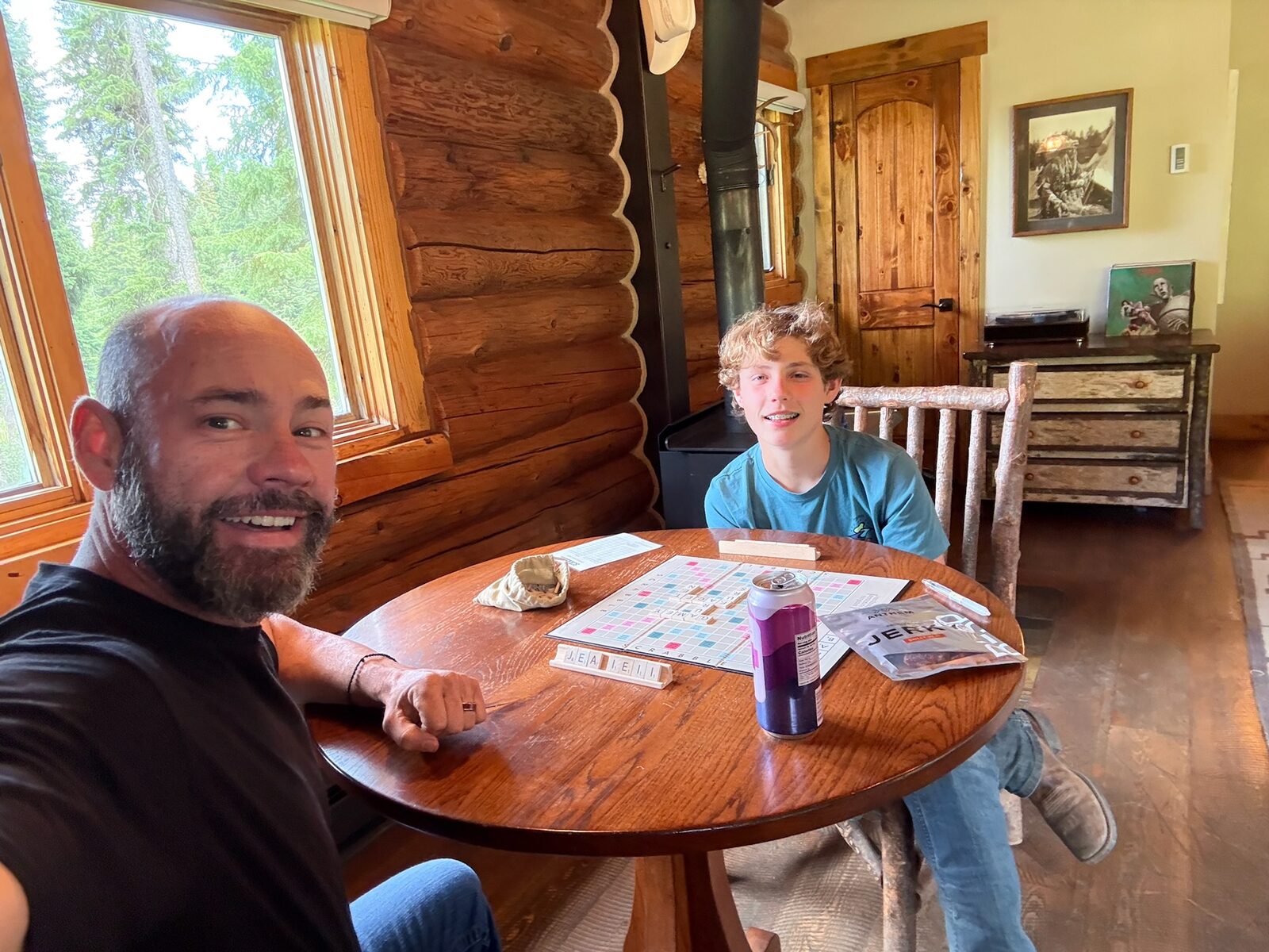 Mark and Dylan playing a game at the cabin table