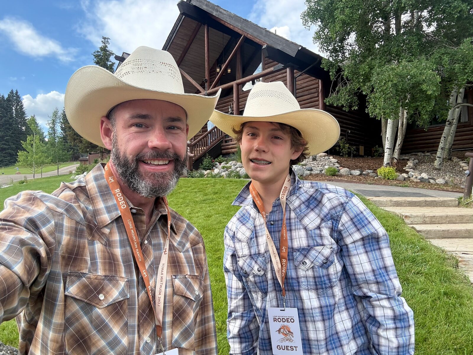Mark and Dylan in pearl-snap shirts with rodeo guest badges